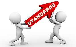 Two people lifting up an arrow saying 'standards'